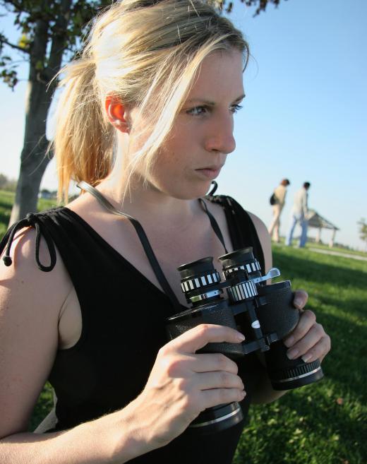 Binoculars may be used during a stakeout.