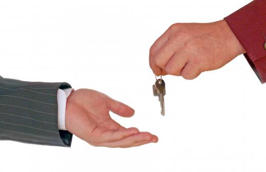 A person returning keys to a repossessor.