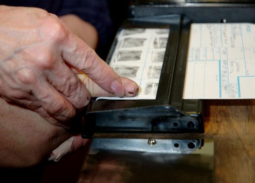 Fingerprints are taken as part of an arrest report.